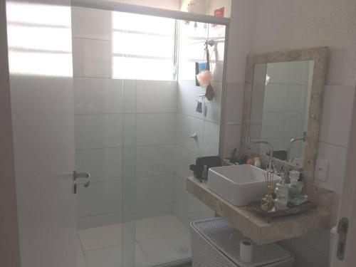 a bathroom with a sink and a shower with a mirror at Petrolina in Petrolina