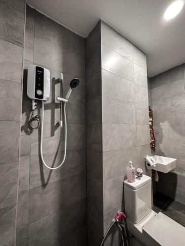 a bathroom with a shower and a toilet and a sink at Disneyland Theme DFB homestay 03 Gala City Armadale Residence in Kuching