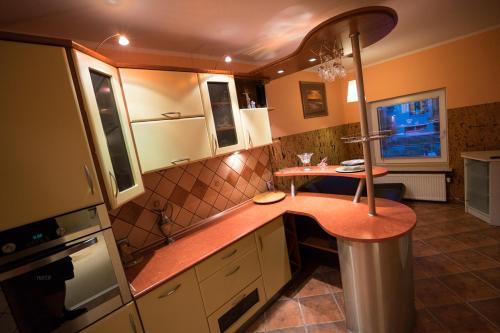 a kitchen with a counter and a table in it at Willa Promenada in Jastarnia