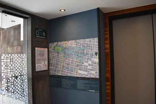 a wall with a map on it next to a door at Continental Mexicano in Mexico City