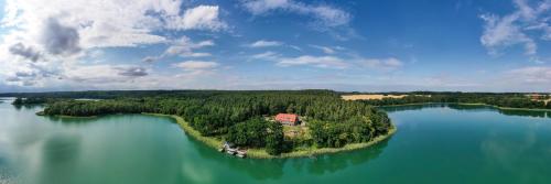 an island in the middle of a large body of water at Seehotel Lichtenberg in Lichtenberg