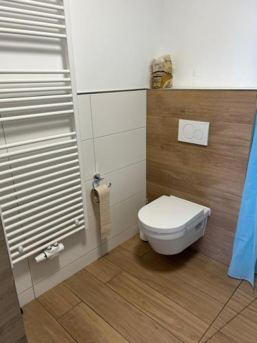 a bathroom with a white toilet and a window at Apartment Fuchs in Espelkamp