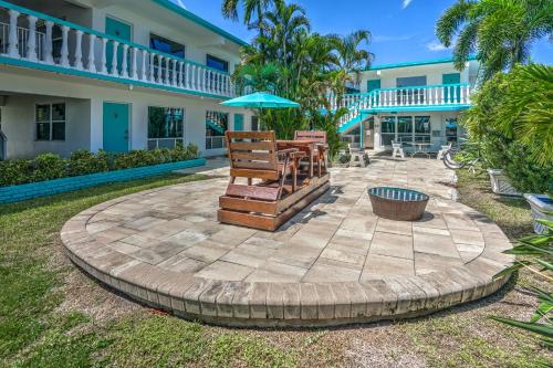 a patio with chairs and an umbrella in front of a building at Horizon by the Sea Inn in Fort Lauderdale