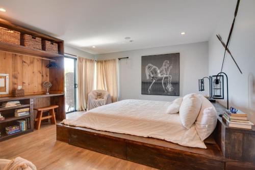 a bedroom with a large bed and a desk at Malibu Retreat with Balcony and Mountain Views in Malibu