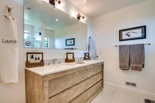 a bathroom with a large sink and a large mirror at Malibu Retreat with Balcony and Mountain Views in Malibu
