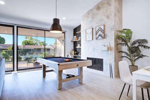 a pool table in a living room with a fireplace at Cali Desert Life - Pool, Golf Cart, Tennis, Bikes in Indian Wells