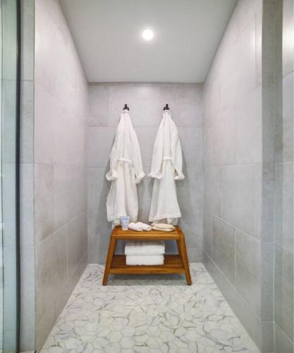 a bathroom with a shower with white towels at Cali Desert Life - Pool, Golf Cart, Tennis, Bikes in Indian Wells