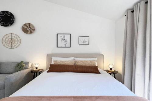 a bedroom with a large white bed and a couch at Cali Desert Life - Pool, Golf Cart, Tennis, Bikes in Indian Wells