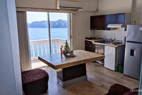 a kitchen with a table with a christmas tree on it at Luxurious Apartment, Oceanfront, spectacular view in Acapulco