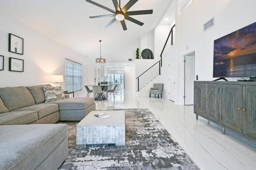 a living room with a couch and a table at Spacious+Cozy Home, near the beach, heated pool. in Naples