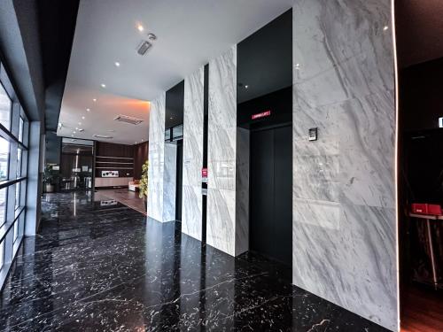 an office lobby with black and white marble walls at Disneyland Theme DFB homestay 03 Gala City Armadale Residence in Kuching