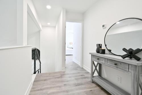 a mirror on a dresser in a white room at Spacious+Cozy Home, near the beach, heated pool. in Naples