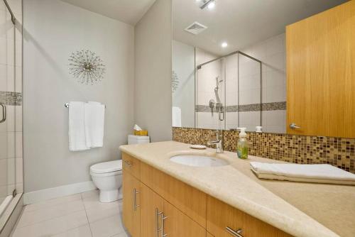 a bathroom with a sink and a toilet at Legacy On Mara Lake- Unit 608 in Sicamous