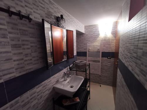 a bathroom with a sink and a mirror at The Best House in Reggio Emilia