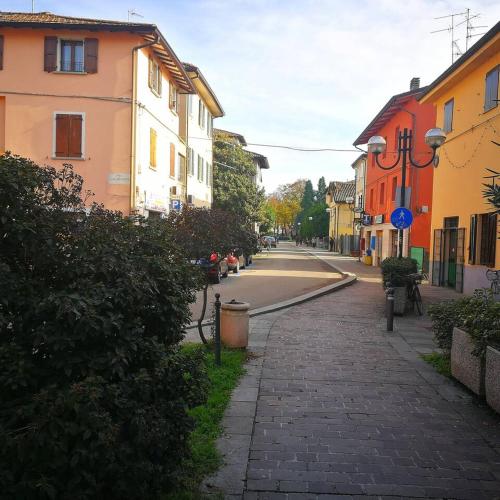 a cobblestone street in a town with buildings at The Best House in Reggio Emilia