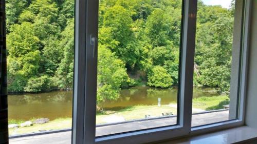 an open window with a view of a river at J-Club De Knapzak / La Besace in Bohan