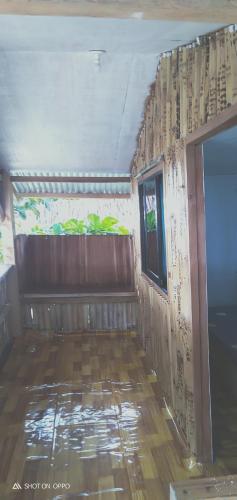 a room with a wooden floor and a window at beach Housenice view beach in Mananda