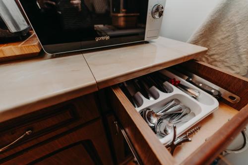 a drawer with utensils in it on a kitchen counter at Pleta View in Vatra Dornei