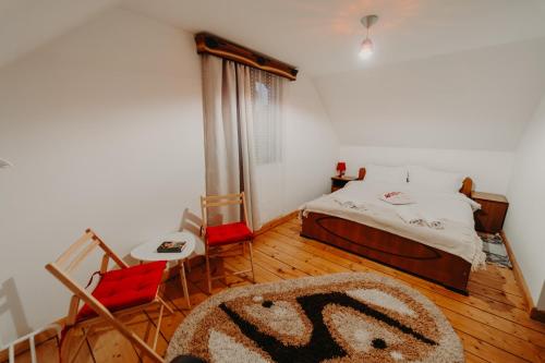 a bedroom with a bed and a rug on the floor at Pleta View in Vatra Dornei