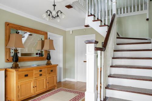 a staircase in a home with a wooden stair case at The Ridgewood Lodge in Newbridge