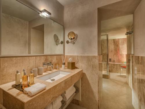 a bathroom with a large sink and a shower at Hotel Punta Tragara in Capri
