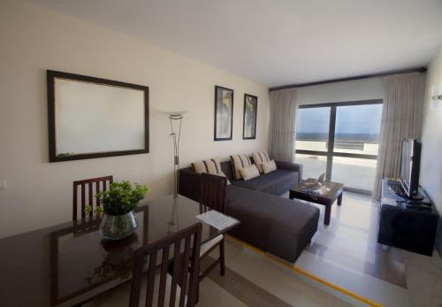 a living room with a couch and a table at Vip Executive Suites Maputo in Maputo