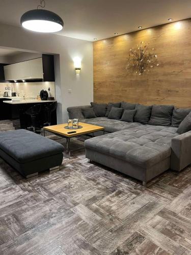 a living room with a couch and a table at Guest House EGO in Bratsigovo