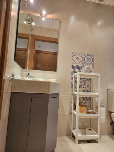 La salle de bains est pourvue d'un lavabo, d'un miroir et de toilettes. dans l'établissement Apartments Zarate, à Grenade