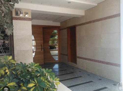 a hallway of a house with a door and some plants at Super maisons a 2 pas d'agadir in Ait Melloul