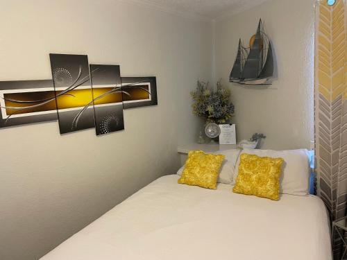 a bedroom with a bed with two yellow pillows at Casa Del Mar Sun Diamond One Bedroom Retreat - Galveston in Galveston