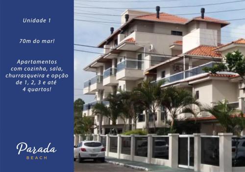 a white car parked in front of a building at Parada Beach Beira-Mar e Aptos 70m do Mar in Florianópolis