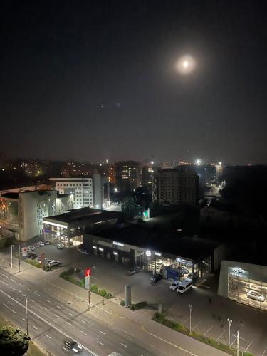 a view of a city at night with a full moon at Апартаменти Люкс 4 in Khmelnytskyi