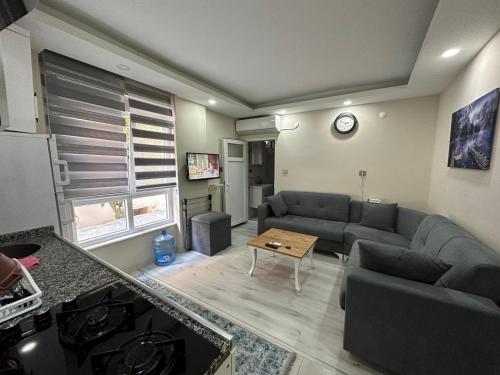 a living room with a couch and a table at Tatil için ev in Antalya