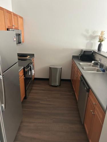 a kitchen with a stainless steel refrigerator and a sink at Luxury loft in the heart of downtown Memphis in Memphis