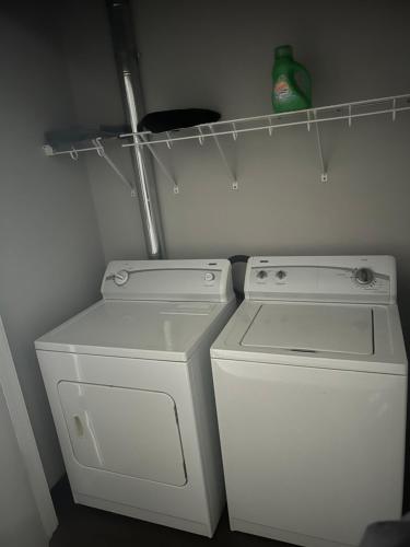a small kitchen with a washing machine and a washer at Luxury loft in the heart of downtown Memphis in Memphis