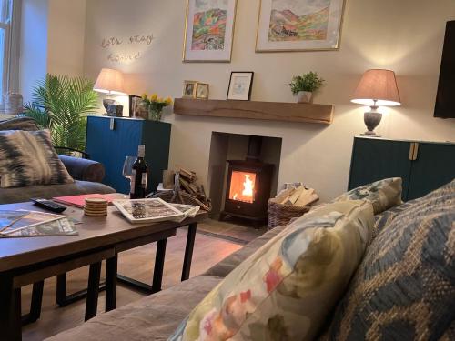 a living room with a couch and a fireplace at Tranquil Appleby Retreat for 6 Guests with Hot Tub in Appleby
