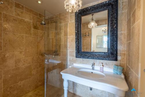a bathroom with a sink and a mirror at Marina view apartments in Kralendijk