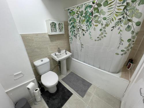a bathroom with a toilet and a sink at Luminous Family Flat (4 guests) in London