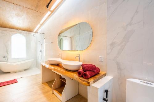 a bathroom with two sinks and a mirror at Luxury Villa Belvedere Bali in Seminiak in Legian