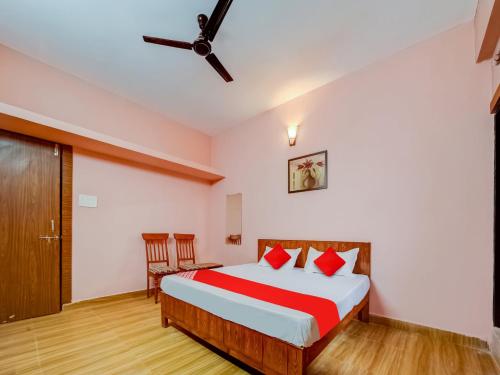 a bedroom with a bed and a ceiling fan at Hotel Crown Square in Bhopal