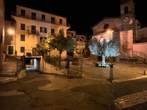 a street at night with a building and a tree at Short let SanRocco in Olevano Romano