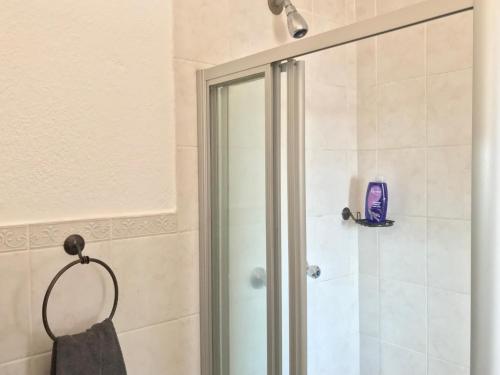 a shower with a glass door in a bathroom at Studio Eazi in Midrand
