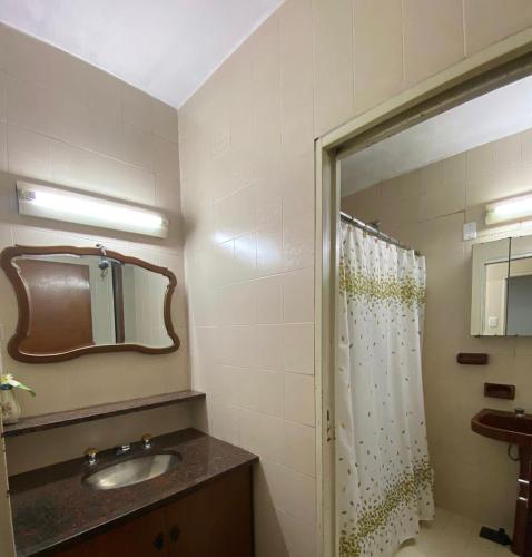 a bathroom with a shower and a sink and a mirror at Casa Mamu en microcentro in Resistencia