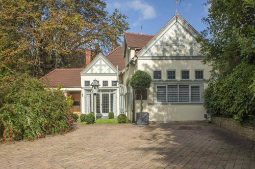 a white house with a brick driveway at Beautiful Secluded 2 Bedroom Coach House in Nottingham