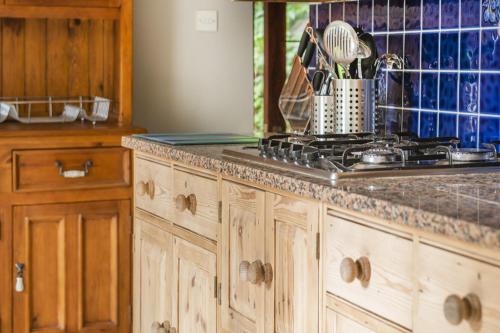 a kitchen with a stove and a counter top at Beautiful Secluded 2 Bedroom Coach House in Nottingham