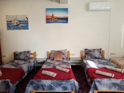 a room with two twin beds and paintings on the wall at Apartman HAX in Sjenica