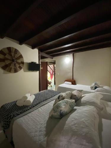 a bedroom with three beds with a dog laying on them at Pousada Natureza Viva in Itacaré