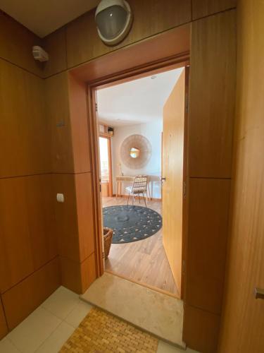 a room with a door open to a living room at Apartamento Raposo in São Roque
