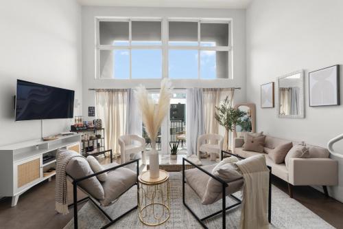 a living room with a couch and a tv at The Italian Retreat, Little Italy in San Diego