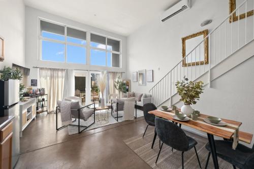 a dining room and living room with a table and chairs at The Italian Retreat, Little Italy in San Diego